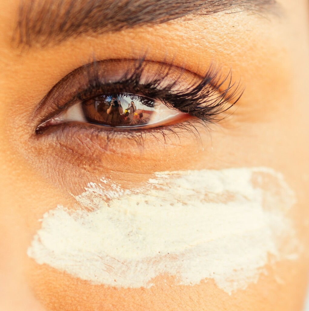 cute hispanic girl apply tone cream on perfect skin .anti acne concept.